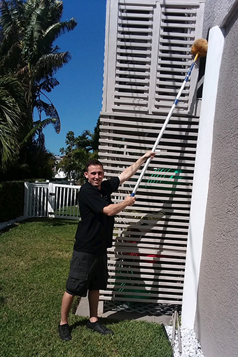 Pest Control Professional Removing Hornets in a Building in Tarpon Springs FL
