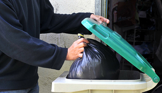 Holiday Homeowner Throwing Trash Left by Opossum Removal Company